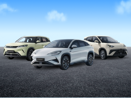 Three electric vehicles displayed on a road against a blue sky background