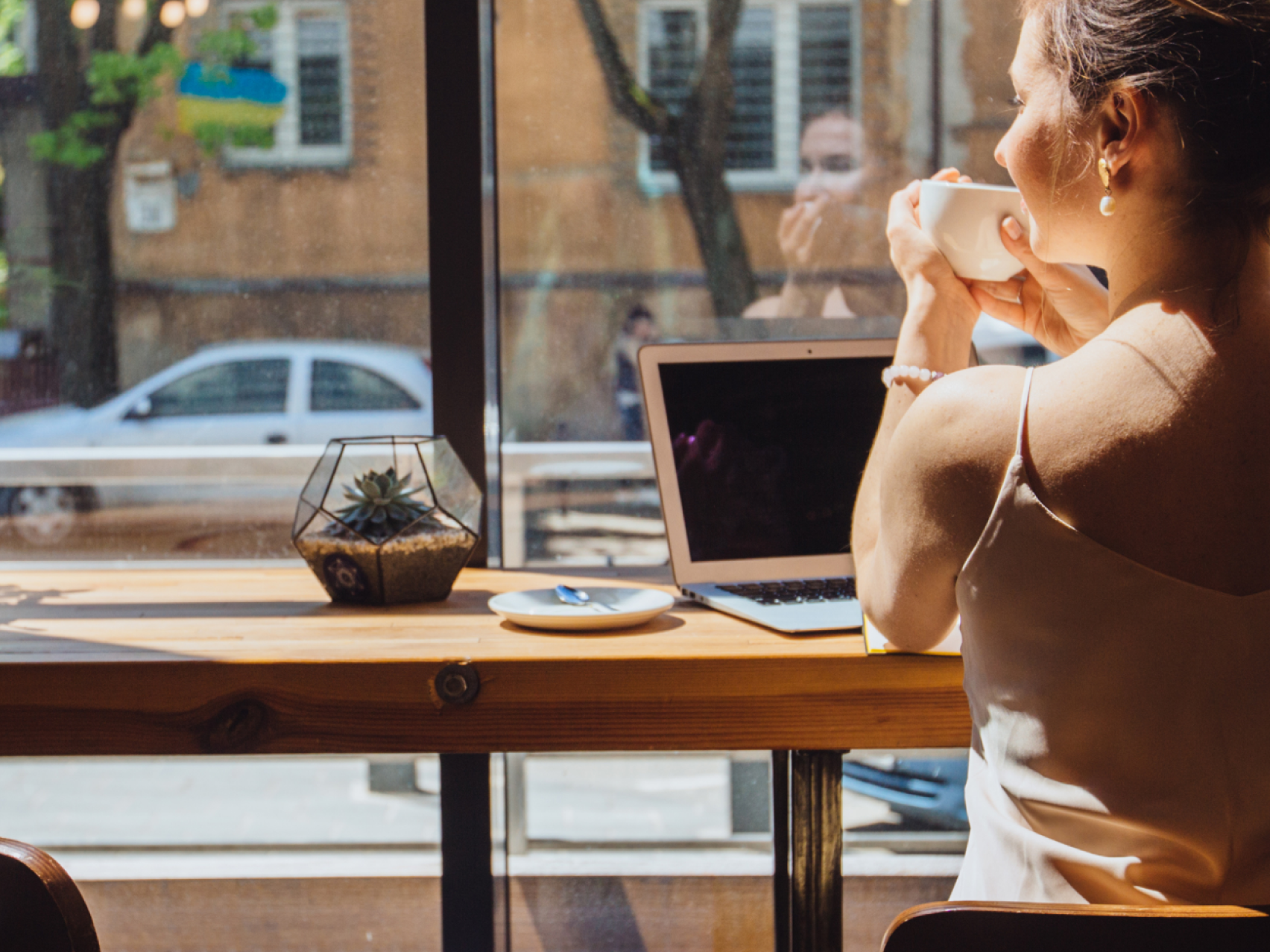 Person drinking coffee at a cafe