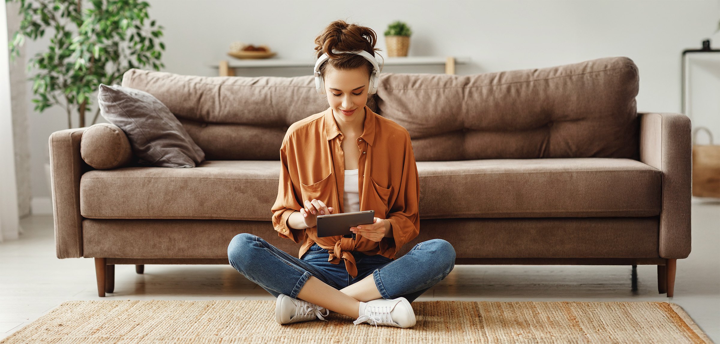 Woman listening to music in front of couch