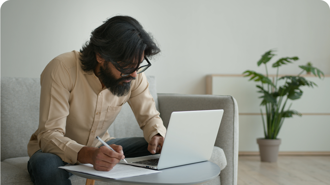 Man on laptop, calculating superannuation contributions