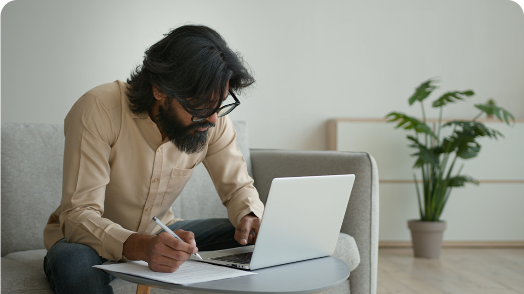 Man on laptop, calculating superannuation contributions