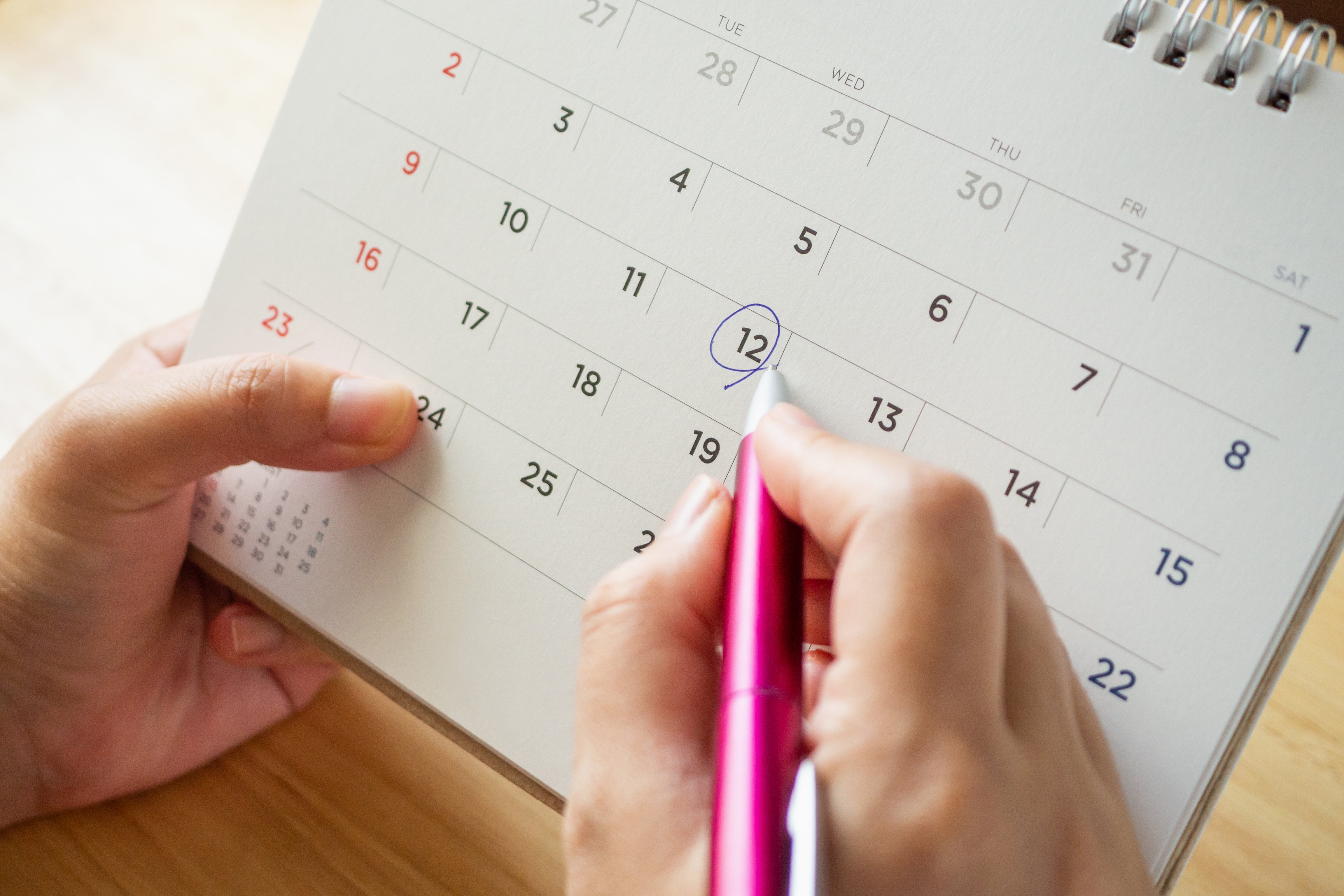 Person writing on Calendar