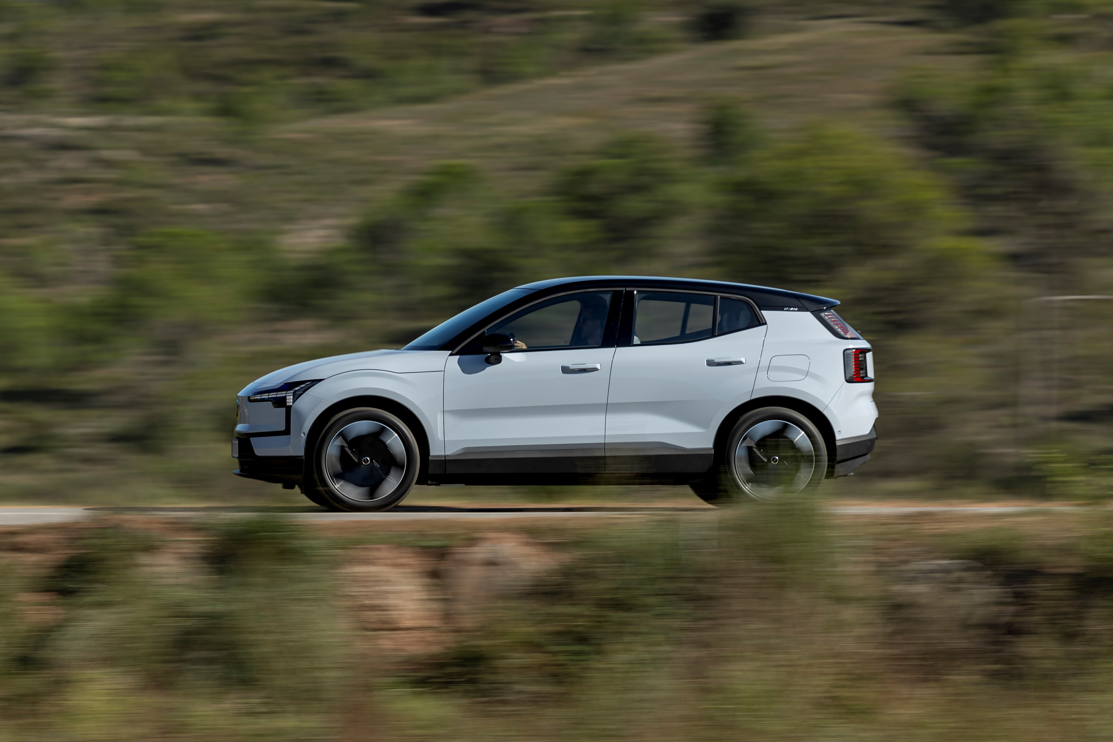 Volvo EX30 in motion on country road