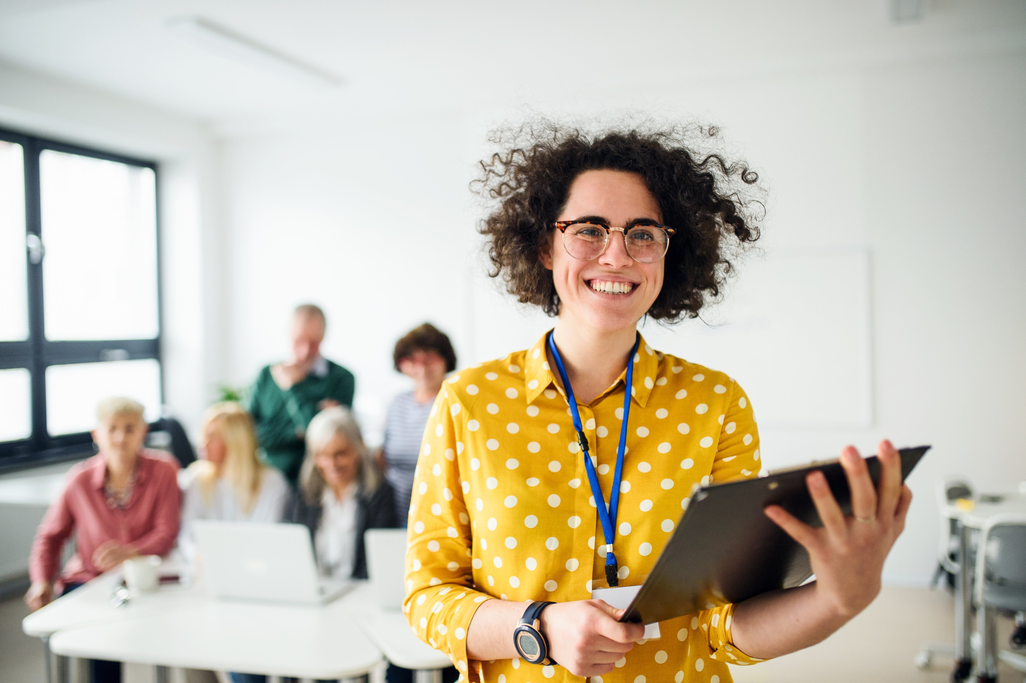 Teacher with clipboard in front of class