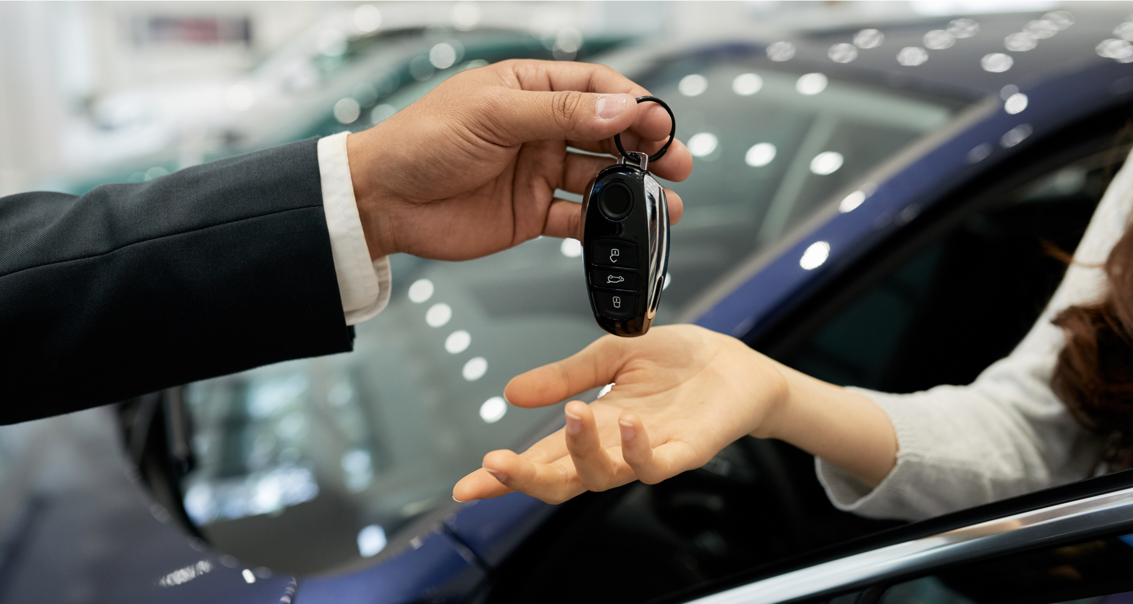 Someone handing over a set of keys to another person