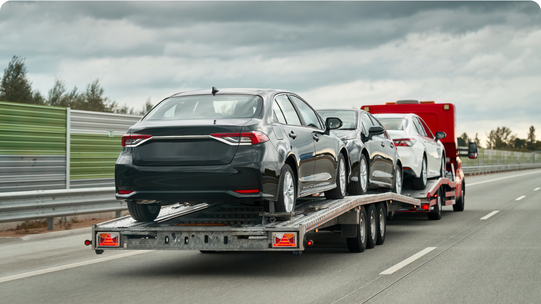 Cars being transported on a trailer  