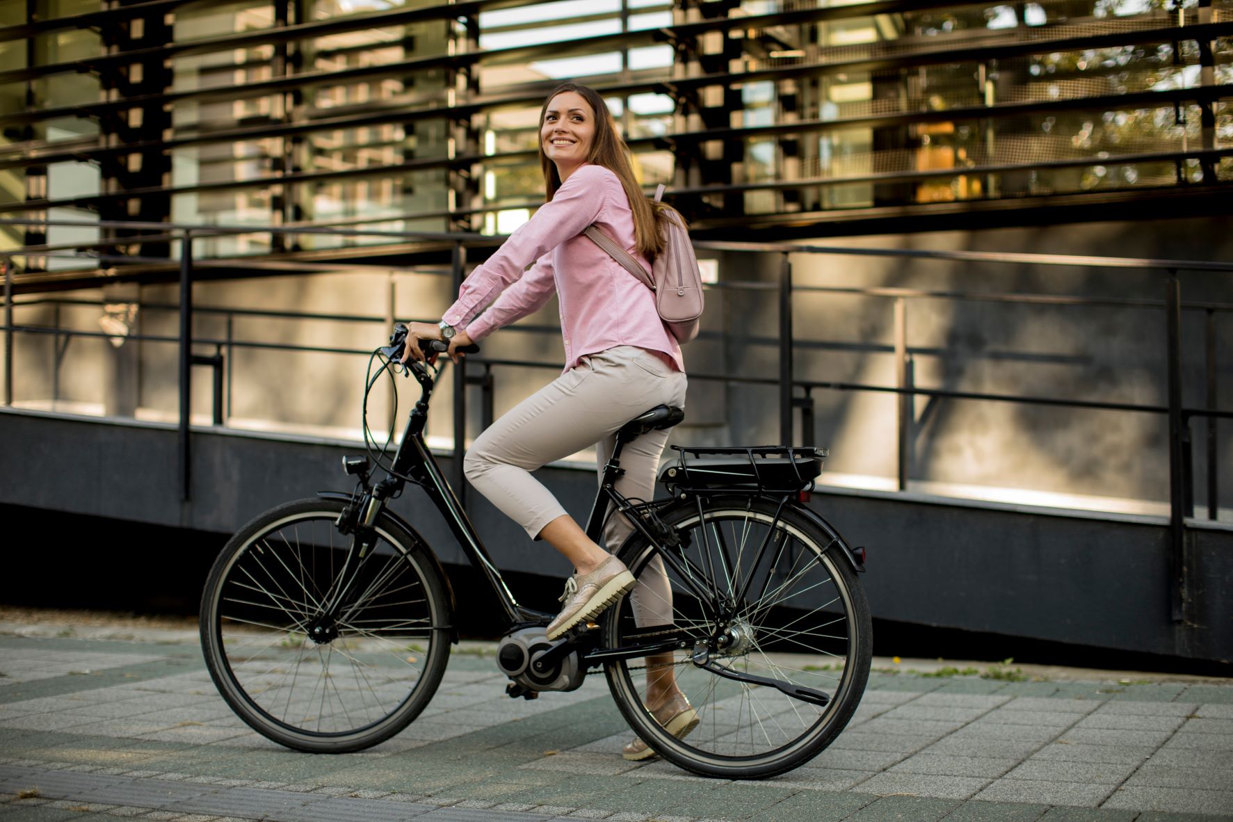 Women in a pink top riding a e-bike